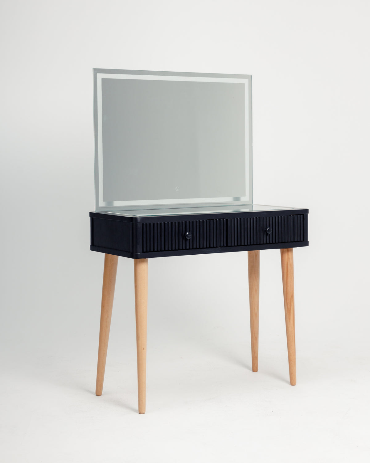 A modern black dresser with a ribbed front design features two drawers and light wooden legs. It is topped with a large, minimalist mirror, creating a stylish and functional piece suitable for any bedroom or vanity area.